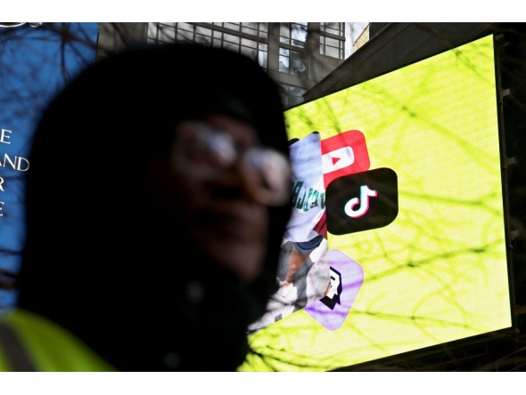 The Tik Tok Logo is displayed on a billboard at Times Square in New York City on January 17, 2025. (Photo by Leonardo Munoz / AFP)
