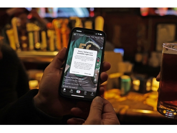 A TikTok user holds a phone showing the screen of the social media app on January 18, 2025 in Washington, DC. (Photo by Justin Sullivan/Getty Images/AFP)