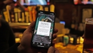 A TikTok user holds a phone showing the screen of the social media app on January 18, 2025 in Washington, DC. (Photo by Justin Sullivan/Getty Images/AFP)