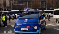 A Seoul Regional Corrections inmate transport vehicle believed to be carrying the South Korean President Yoon Suk Yeol arrives at Seoul Western District Court on Saturday. (Photo by Jintak Han/The Washington Post)
