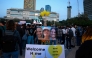 Supporters and relatives of Israeli detainees Romi Gonen, Emily Damari, and Doron Steinbrecher, watch a live television broadcast on their release on January 19, 2025.(Photo by Menahem Kahana / AFP)