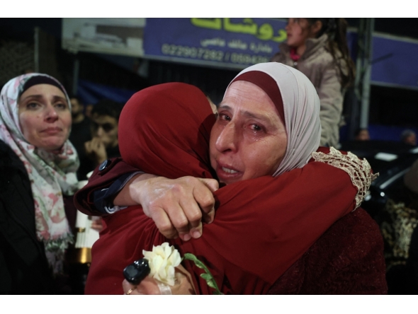 A Palestinian woman cries as she embraces a loved one who was released from Israeli jail in the early hours of January 20, 2025. (Photo by Zain Jaafar / AFP)