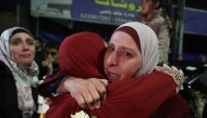 A Palestinian woman cries as she embraces a loved one who was released from Israeli jail in the early hours of January 20, 2025. (Photo by Zain Jaafar / AFP)