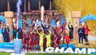 Al Wahda players and officials celebrate after winning the Qatar-UAE Super Cup Challenge Cup.