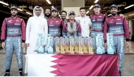 Qatar Motor and Motorcycle Federation Executive Director Amro Al Hamad celebrates with the members of the QMMF HRT team at Yas Marina Circuit in Abu Dhabi, yesterday.