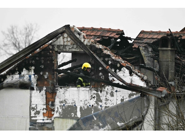 A fireman inspects damages caused by a fire at a retirement home, on the outskirts of Serbia's capital Belgrade on January 20, 2025. (Photo by Andrej Isakovic / AFP)