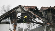 A fireman inspects damages caused by a fire at a retirement home, on the outskirts of Serbia's capital Belgrade on January 20, 2025. (Photo by Andrej Isakovic / AFP)