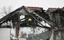 A fireman inspects damages caused by a fire at a retirement home, on the outskirts of Serbia's capital Belgrade on January 20, 2025. (Photo by Andrej Isakovic / AFP)