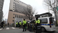 Policemen stand guard in front of the main gate at the Seoul Western District Court in Seoul on January 20, 2025, after supporters of South Korean President Yoon Suk Yeol stormed the building on January 19. (Photo by Jung Yeon-je / AFP)