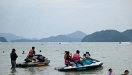 Visitors rent jet skis at Pantai Cenang in Malaysia's Langkawi Island on January 19, 2025. (Photo by Mohd Rasfan / AFP)