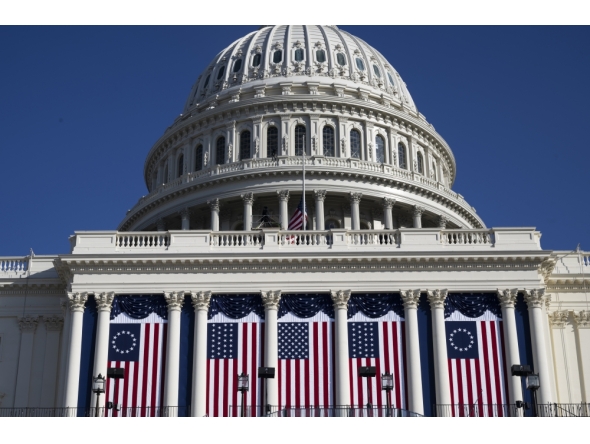 The Capitol is adorned with flags ahead of President-elect Donald Trump's second inauguration. (Photo by Marvin Joseph/The Washington Post)
