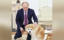 Russian President Vladimir Putin pets his Akita dog Yume at the Russian presidential office in Moscow in December 2016 / The Japan News