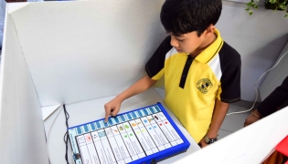 A student casting his vote.