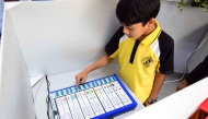 A student casting his vote.