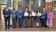 Principal, other officials and Birla Public School students with medals and certificates they received in the competition.