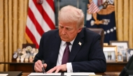 US President Donald Trump signs executive orders in the Oval Office of the White House in Washington, DC, on January 20, 2025. Photo by Jim WATSON / POOL / AFP.
