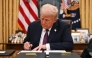 US President Donald Trump signs executive orders in the Oval Office of the White House in Washington, DC, on January 20, 2025. Photo by Jim WATSON / POOL / AFP.
