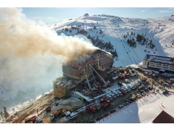 This handout photograph released by the Demiroren News Agency (DHA) on January 21, 2025, shows an aerial picture of a fire on the fourth floor of the 11-storey hotel in Bolu's Kartalkaya ski resort. (Photo by DHA (Demiroren News Agency) / AFP)