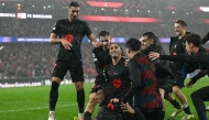 Barcelona's Brazilian forward #11 Raphinha (C) celebrates victory with teammates at the end of the UEFA Champions League, league phase football match between SL Benfica and FC Barcelona at Luz stadium in Lisbon on January 21, 2025. Barcelona won 4-5. (Photo by Patricia DE MELO MOREIRA / AFP)
