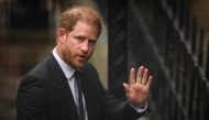 (Files) Britain's Prince Harry, Duke of Sussex waves as he arrives at the Royal Courts of Justice, Britain's High Court, in central London on March 28, 2023. (Photo by Daniel Leal / AFP)