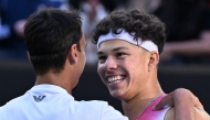 USA's Ben Shelton (R) greets Italy's Lorenzo Sonego (L) after his victory in their men's singles quarter-final match on day eleven of the Australian Open tennis tournament in Melbourne on January 22, 2025. (Photo by William West / AFP) /