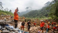 Rescue teams, including Indonesia's National Search and Rescue Agency (BASARNAS), the army, police, and volunteers, use high-pressure water to search for victims of a landslide triggered by heavy rain two days ago, which has so far claimed 19 lives, in Kasimpar Village, Central Java, on January 22, 2025. (Photo by DEVI RAHMAN / AFP)
