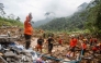 Rescue teams, including Indonesia's National Search and Rescue Agency (BASARNAS), the army, police, and volunteers, use high-pressure water to search for victims of a landslide triggered by heavy rain two days ago, which has so far claimed 19 lives, in Kasimpar Village, Central Java, on January 22, 2025. (Photo by DEVI RAHMAN / AFP)
