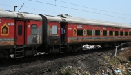 File photo for representation only. A passenger looks out from a carriage of a long-distance train in India. (Punit PARANJPE / AFP)