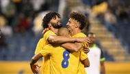 Al Gharafa's Ferjani Sassi (left) celebrates with teammates.