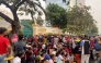 This photo taken and released by Fresh News shows a crowd gathering at the mansion of Cambodian tycoon Sok Kong to receive red envelopes, in Phnom Penh. (Photo by Fresh News / AFP) 