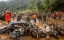 Rescue teams, including Indonesia's National Search and Rescue Agency (BASARNAS) and the Indonesian National Defence Forces (TNI), recover motorcycles from the mud following a landslide triggered by heavy rains in Kasimpar village, Central Java, on January 22, 2025. 