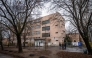 People stand in front of an empty school in Budapest on January 23, 2025 following bomb threats. (Photo by FERENC ISZA / AFP)
