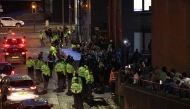 Police contain protesters as news spreads that Axel Rudakubana has left the court from a back entrance, outside The Queen Elizabeth II Law Courts in Liverpool, north west England on January 23, 2025, after the sentencing of the Southport attacker. (Photo by Darren Staples / AFP)
