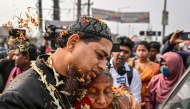 A former member of the Bangladesh Rifles (BDR), who were detained in 2009 over a violent mutiny that massacred dozens of senior army officers, meets with his relative after getting released from the Dhaka Central Jail in Keraniganj on the outskirts of Dhaka on January 23, 2025. (Photo by Munir Uz Zaman / AFP)