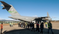 Handout picture released by Guatemalan Migration Institute shows Guatemalan migrants descending from an US military plane after being deported from US on January 24, 2025. (Photo by Handout / Guatemalan Migration Institute / AFP) 