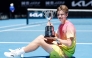 Switzerland's Henry Bernet poses with the winner's trophy after his victory in junior boys' singles final match in Melbourne on January 25, 2025. (Photo by Martin Keep / AFP) 