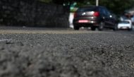 This photograph taken on December 26, 2024 shows vehicles riding over a road built using recycled plastic waste in Pokhara. (Photo by Prakash Mathema / AFP) 