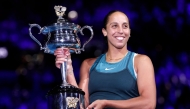 USA's Madison Keys celebrates with the Daphne Akhurst Memorial Cup after defeating Belarus' Aryna Sabalenka in Melbourne on January 25, 2025. (Photo by Martin Keep / AFP)