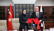 Chairperson of National Human Rights Committee H E Maryam bint Abdullah Al Attiyah and Chief Ombudsman of Turkiye H E Mehmet Akarca showing documents after signing the agreement.