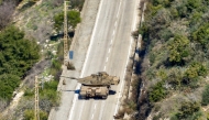 This picture taken from Lebanon's southern village of Shaqra on January 25, 2025 shows an Israeli army Merkava main battle tank moving along a road at the entrance of the village of Hula in south Lebanon. Photo by AFP.
