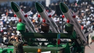 A soldier salutes next to an Akash missile system during country's 76th Republic Day parade in New Delhi on January 26, 2025. (Photo by Sajjad Hussain / AFP)