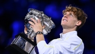 Italy's Jannik Sinner celebrates with the Norman Brookes Challenge Cup trophy after defeating Germany's Alexander Zverev during their men's singles final match on day fifteen of the Australian Open tennis tournament in Melbourne on January 26, 2025. (Photo by WILLIAM WEST / AFP)