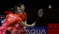 China's Guo Xinwa and Chen Fanghui hit a return against Japan's Hiroki Midorikawa and Natsu Saito in the mix doubles final match at the Daihatsu Indonesia Masters 2025 badminton tournament at Istora stadium in Jakarta on January 26, 2025. (Photo by BAY ISMOYO / AFP)
