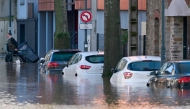 This photograph shows cars in a street following exceptional floodin of the Ille river in Rennes, western France on January 27, 2025. (Photo by Damien Meyer / AFP)