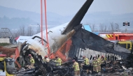 Firefighters and recovery teams work at the scene where a Jeju Air Boeing 737-800 series aircraft crashed and burst into flames at Muan International Airport in Muan, some 288 kilometres southwest of Seoul on December 30, 2024. Photo by JUNG YEON-JE / AFP