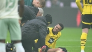 Dortmund's injured German midfielder #08 Felix Nmecha reacts on the pitch during the German first division Bundesliga football match BVB Borussia Dortmund vs Werder Bremen in Dortmund, western Germany, on January 25, 2025. (Photo by INA FASSBENDER / AFP)