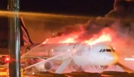 Fire authorities work to extinguish a fire that broke out on an Air Busan passenger plane at Gimhae International Airport in Busan on January 28, 2025. Photo by YONHAP / AFP