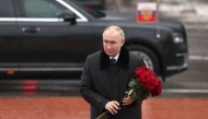 In this pool photograph distributed by the Russian state agency Sputnik, Russian President Vladimir Putin lays flowers at the monument 'Rubezhny Kamen' (Boundary Stone) in Kirovsk, Leningrad region, on January 27, 2025, marking the 81st anniversary of the liberation of Leningrad from Nazi blockade in World War Two. (Photo by Vyacheslav Prokofyev / POOL / AFP)