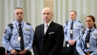 Mass killer Anders Behring Breivik is seen surrounded by prison guards on the fourth and last day in court in Skien prison Norway March 18 2016 REUTERS Lise Asreud