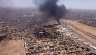 (FILES) This image grab taken from AFPTV video footage on April 20, 2023, shows an aerial view of black smoke rising above the Khartoum International Airport amid ongoing battles between the forces of two rival generals. (Photo by AFP)
